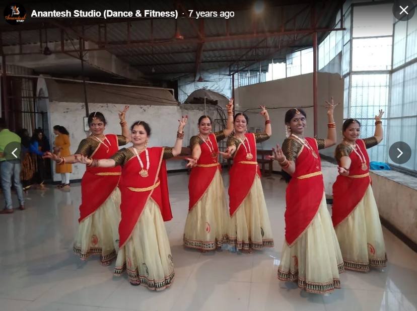 Traditional dance group in red and gold costumes