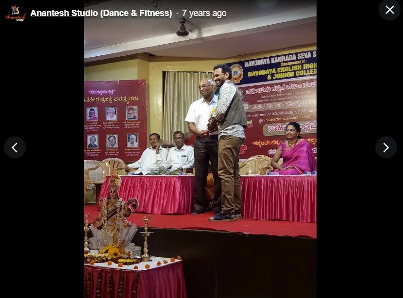Founder being felicitated on stage at a cultural event